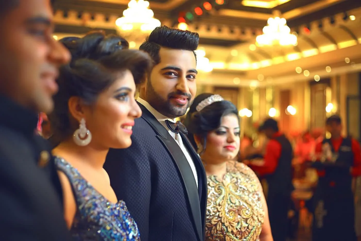 Couple and guests at a lit banquet reception in Delhi