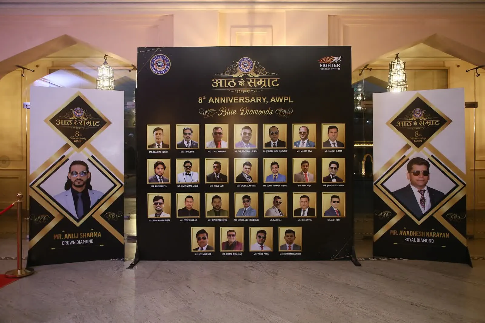 Anniversary awards board displaying company leadership portraits at a corporate event