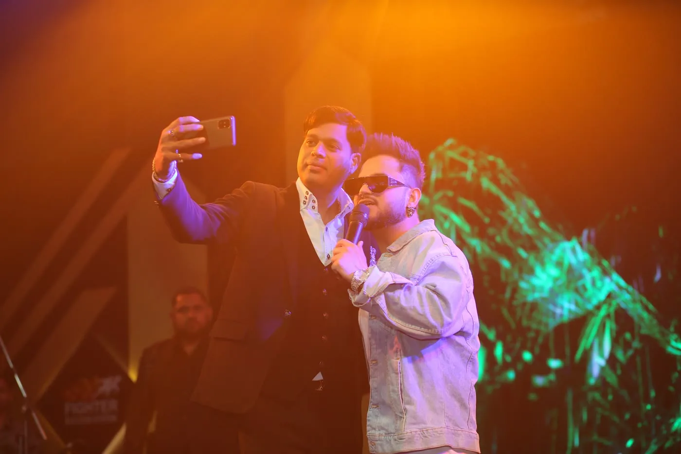 Stage performance with concert lighting at a corporate celebration