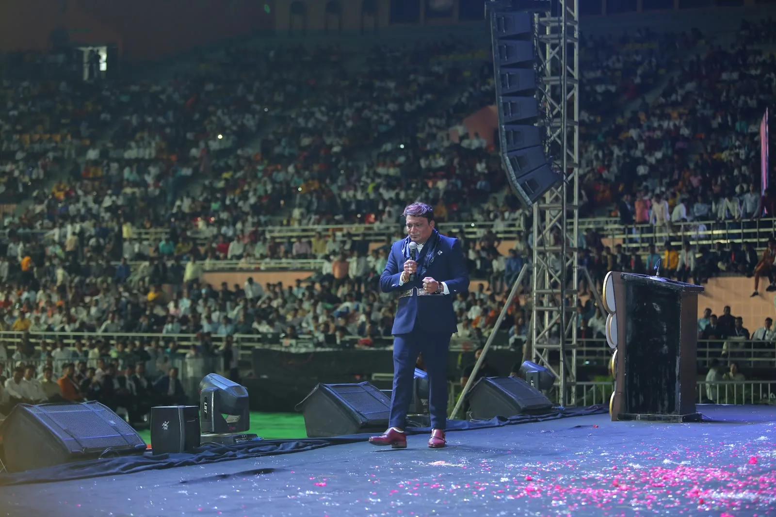 Keynote speaker on stage with confetti at a Delhi corporate event