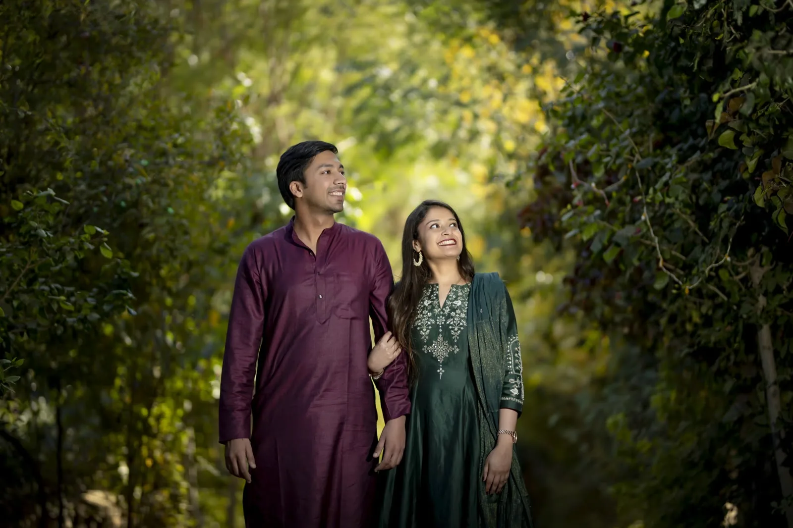 Pre-wedding couple portrait framed by a historic stone archway in Delhi