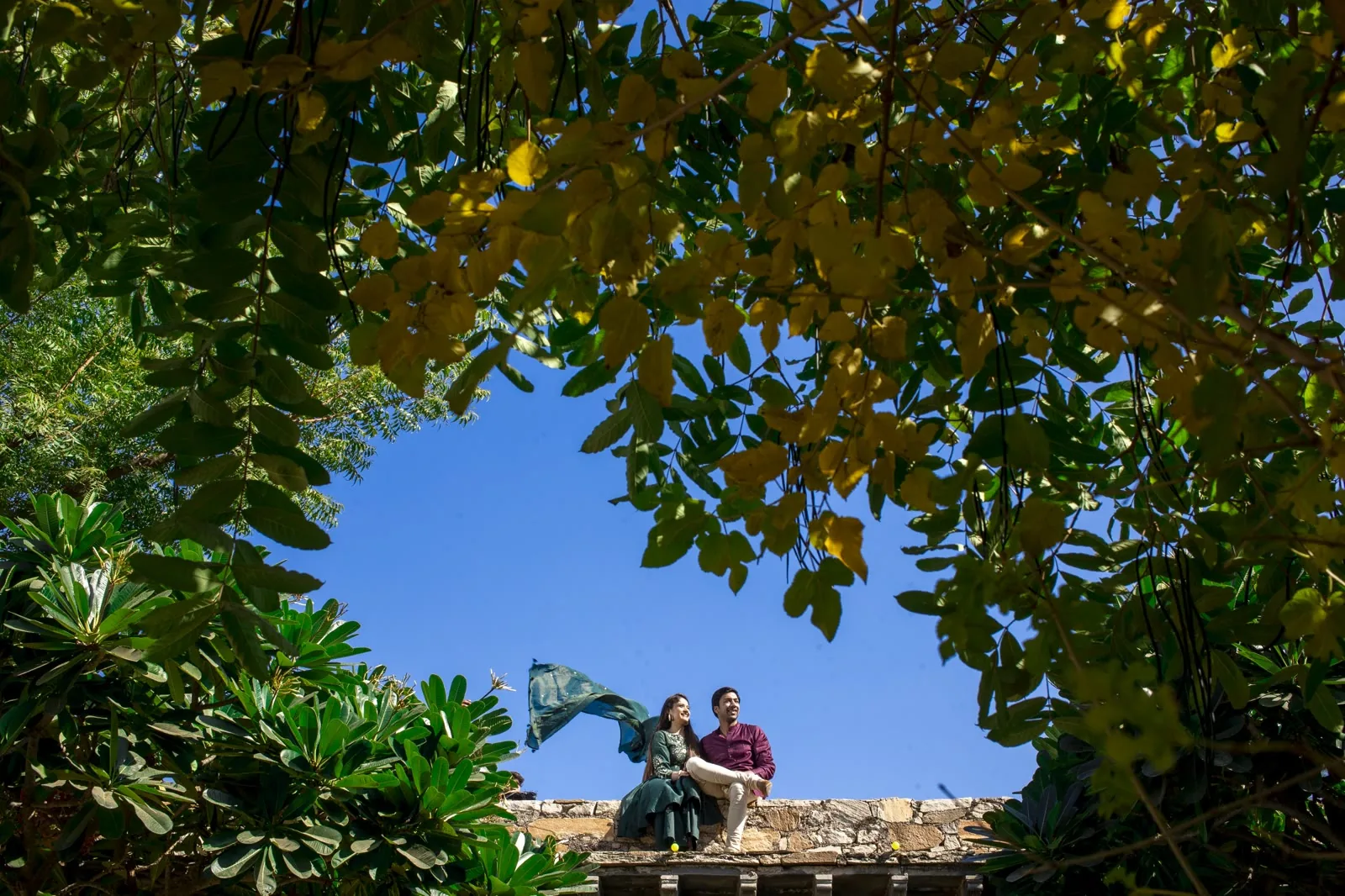 Couple walking a tree-lined path during a pre-wedding shoot