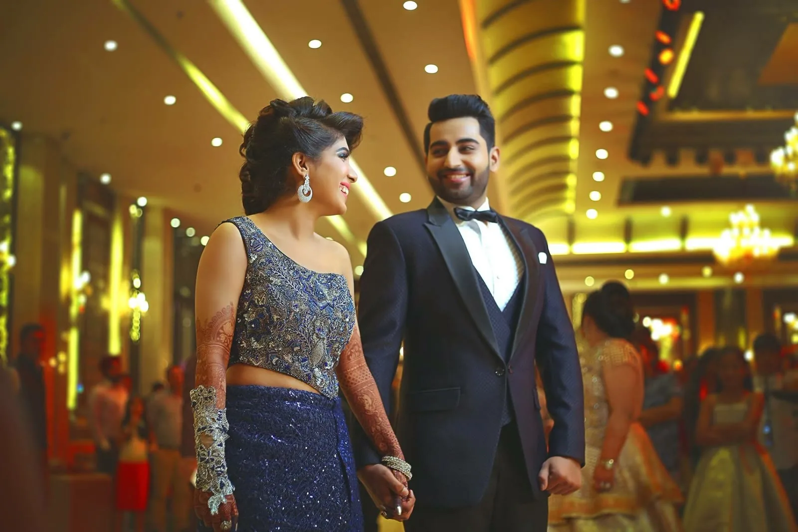 Couple walking through a decorated banquet hall at their engagement
